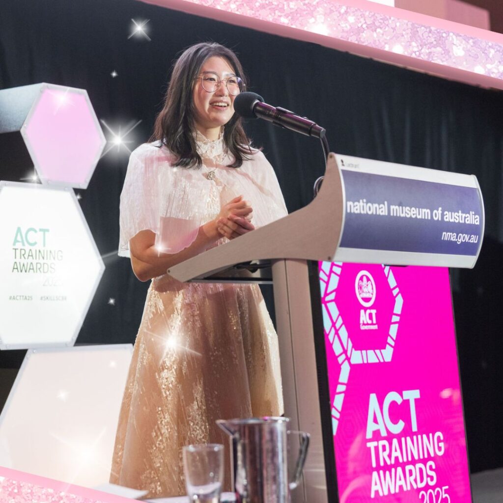 Jiwon accepting ACT Trainee of the Year award 2025.